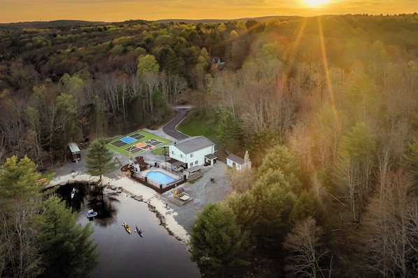 Aerial view of your 7-acre estate with private lake, pool, and trails.