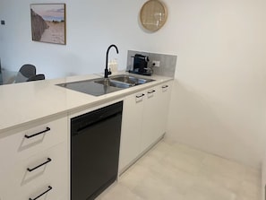 Kitchen with dishwasher and coffee machine