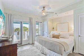 Master Bedroom: King bed, 75" smart TV, private balcony with lake views, closet