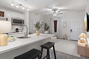 Kitchen: Bar seating, stovetop, microwave, refrigerator, drip coffee maker, cookware & dinnerware
