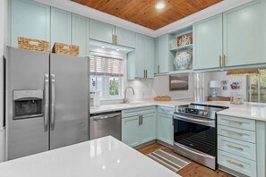 Kitchen: Drip coffee maker, Keurig, cooking utensils, blender, tableware