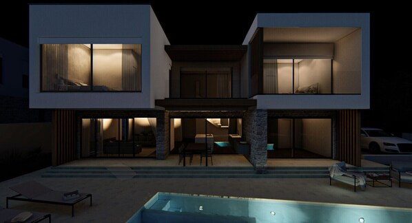 Large villa by night with cozy warm white lightning and salt water pool.