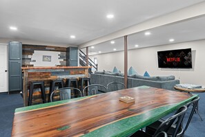 Unwind in this beautifully designed basement featuring a handcrafted rustic bar, a spacious entertainment area, and a large TV for movie nights or game-day gatherings.