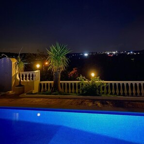 City lights of Albufeira twinkling in the far distance