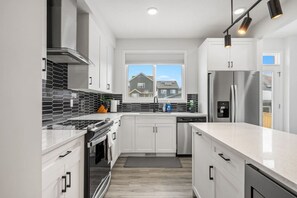 Main floor full kitchen with a drip & Keurig coffee maker, blender & rice cooker.