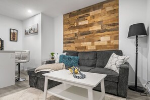 Downstairs living room with a 55" smart TV and a pull-out sofa bed (bedding provided.)
