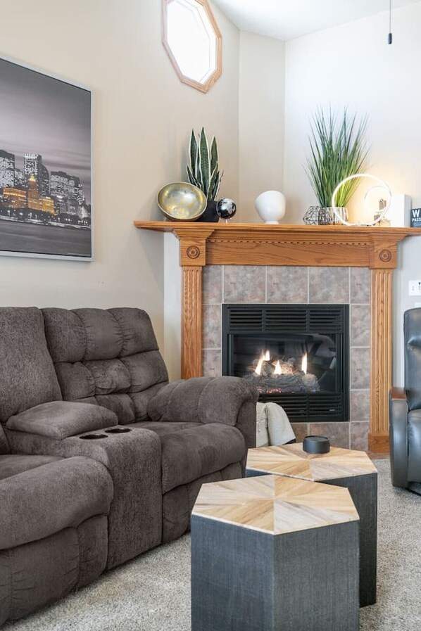 Spacious and warm living room, with a beautiful fireplace to cozy up to.