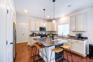 Spacious kitchen with oversized island to eat, gather, work and enjoy.