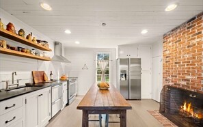 Cozy kitchen with stainless steel appliances, fireplace and all the essentials.