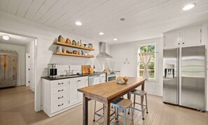 Cozy kitchen with stainless steel appliances, fireplace and all the essentials.