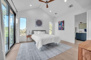 Natural light floods this charming room, complete with a queen-size bed and stylish furniture, making it the perfect spot for a peaceful stay.