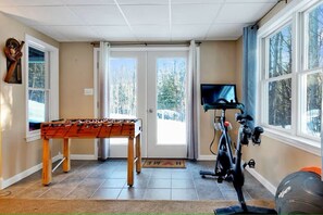 This bright and open game room opens up to the back fenced in yard.