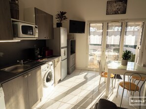 Air-conditioned living room with fully equipped kitchen