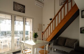 Air-conditioned living room with fully equipped kitchen
