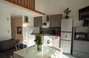 Air-conditioned living room with fully equipped kitchen