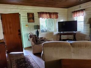 Living room view from behind sofa bed couch and smart TV