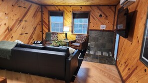 living room/ extra sleeping area with smart tv