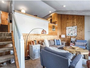 Living room with steps to kitchen