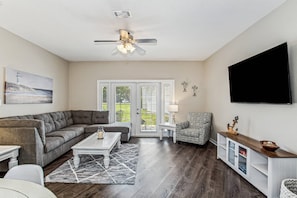 Large open living room with mounted smart TV