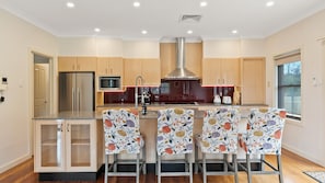 A well-equipped kitchen with plenty of seating for a group.