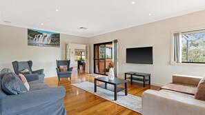 Stylish living area featuring a flat-screen TV for entertainment.