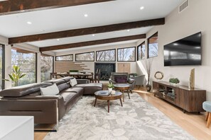 A cozy living room with comfortable seating, warm lighting, and modern décor, offering a welcoming and relaxed atmosphere.
