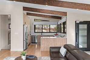 A compact kitchen area with modern appliances, sleek countertops, and efficient storage, perfect for preparing meals in a cozy space.
