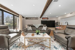 A stylish living room with comfortable seating, soft lighting, and a warm, inviting atmosphere.