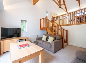 Comfy lounge area with stairs to mezzanine kitchen