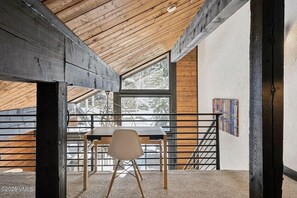 The loft space also has an extra desk for working.