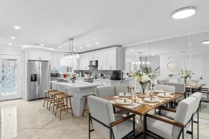Spacious, open-concept kitchen and dining area with seating for six, perfect for chatting while cooking up a tasty meal