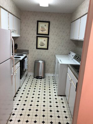 Kitchen with fridge/freezer, washer/dryer, oven/stove, microwave