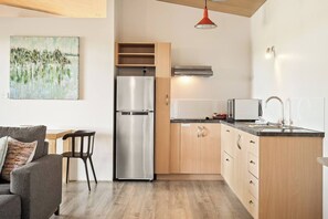 Prepare light meals with ease in the fully equipped kitchenette, featuring a stove, fridge, kettle and toaster.