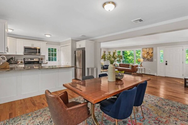 Welcome to Main Street Stay!  Bright and open living space showcasing the seamless flow between the living room, dining area and kitchen