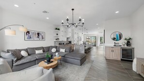 Featuring a smart TV, large plush seating, and an open floor concept that flows seamlessly into the kitchen and dining area for the ultimate blend of comfort and convenience.