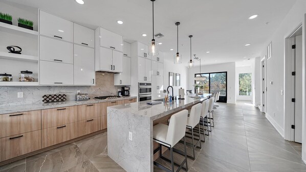 Experience the elegance of open-concept living – an expansive kitchen flows seamlessly into a stylish dining area, perfect for gathering and entertaining.