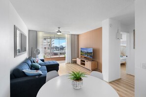 Bright and Spacious Living Area: A sunlit space with natural light streaming in, perfect for relaxing after a day at the beach.