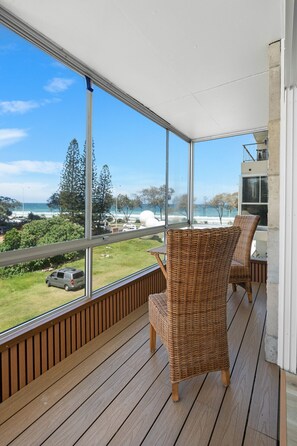 Start your day with breathtaking sunrises over the ocean. The enclosed balcony, complete with timber flooring and inviting outdoor seating, offers the ideal place to relax and take in the scenery.