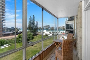 Enjoy uninterrupted views of the beach and ocean from the comfort of your enclosed balcony. The timber decking and cozy outdoor furniture create a perfect spot to soak in the natural beauty.