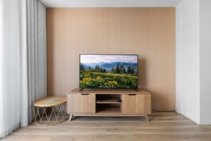 Entertainment Hub: Features a brand-new Smart TV set against a stylish feature wall for your ultimate viewing pleasure.