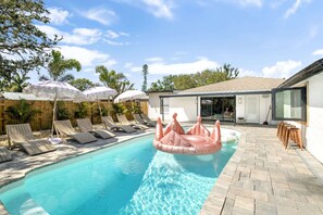Massive Heated Saltwater Pool with Lush Tropical Landscaping, Games and Pool Cabana Game Room.