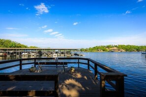 Enjoy a stunning view of the serene lake from the cozy deck, perfect for a relaxing afternoon.  This public swimdeck is part of the Knolls complex and available for guest use.