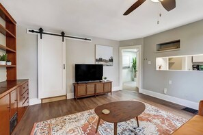 Relax in style in this tastefully decorated living room, where comfort meets cozy design. 