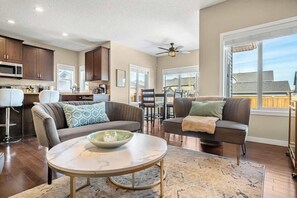 Bright and inviting open-concept living space with modern decor, cozy seating, and ample natural light.