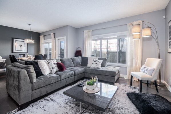 Spacious living area with modern decor and a 55-inch TV for cozy movie nights