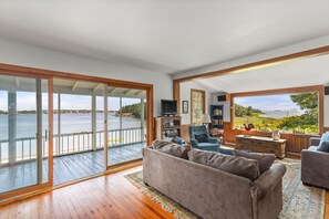 Living room with large picture window and sliding glass doors to porch