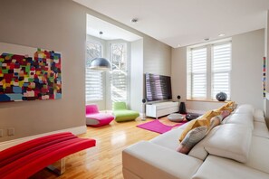 Living Room: Bright, open space with Smart TV and comfy seating