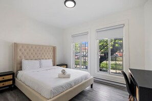 Bedroom 2 - Spacious and airy bedroom featuring a tufted beige headboard