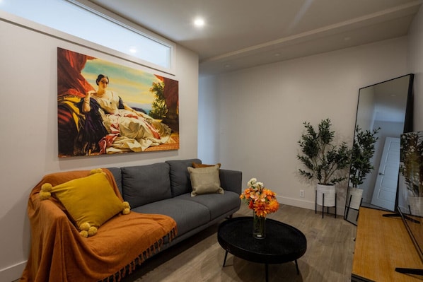 Stylish living room with cozy seating and classic artistic flair.