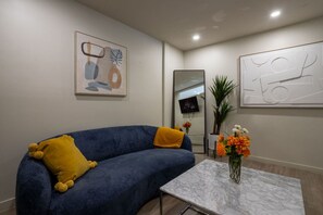 Modern charm and colorful flair in a cozy lounge setting.